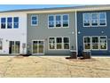 Backyard of townhome featuring a sliding glass door, back patio, and brand new HVAC units at 158 Nimble Way # 226, Clayton, NC 27520