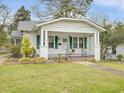 Attractive single-story home boasts a covered porch, green shutters, and a well-manicured front lawn at 1628 Park Dr, Raleigh, NC 27605