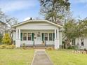 Inviting single-story home with a classic porch, green shutters, and walkway to the entrance at 1628 Park Dr, Raleigh, NC 27605