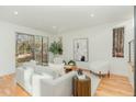 Bright living room with large sliding doors, modern furniture, and light hardwood floors at 168 Daphine Dr, Hillsborough, NC 27278