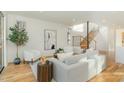 Bright and airy living room with modern decor, hardwood floors, and natural light at 168 Daphine Dr, Hillsborough, NC 27278