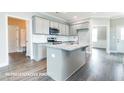 Modern kitchen with granite countertops, stainless steel appliances, and large center island at 169 Tigris Ct, Zebulon, NC 27597