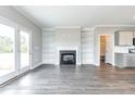 Spacious living room features a fireplace, built-in shelving, and access to the outside at 169 Tigris Ct, Zebulon, NC 27597