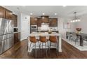 Open kitchen featuring stainless steel appliances, a large island, and stylish seating at 1715 Capstone Dr, Durham, NC 27713