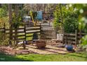 Backyard setting with lounge chairs, hanging chair, and a fire pit for outdoor enjoyment at 202 High St, Carrboro, NC 27510