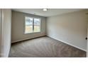Cozy bedroom featuring neutral carpet and bright natural light at 207 N Movado Trl, Kenly, NC 27542