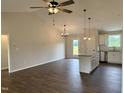 Spacious open-concept living room and kitchen with granite countertops and island at 207 N Movado Trl, Kenly, NC 27542