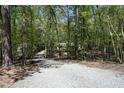 Long gravel driveway leading to a home surrounded by dense trees and natural beauty at 21 Wedgewood Rd, Chapel Hill, NC 27514