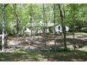 View of the back of the house surrounded by natural landscape with a running stream at 21 Wedgewood Rd, Chapel Hill, NC 27514
