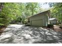 Spacious garage and parking area alongside the house, surrounded by greenery at 21 Wedgewood Rd, Chapel Hill, NC 27514