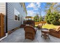 Inviting backyard patio featuring comfortable wicker furniture and a wooden deck, perfect for outdoor relaxation at 2220 Rainy Lake St, Wake Forest, NC 27587