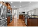 Modern kitchen with stainless steel appliances, granite countertops, and hardwood floors at 2220 Rainy Lake St, Wake Forest, NC 27587