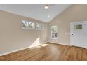 Bright room with vaulted ceiling, stylish flooring, and natural light from multiple windows at 230 N Melville St, Graham, NC 27253