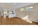 Bright living room with modern flooring, neutral walls, vaulted ceiling and ample natural light from large windows at 230 N Melville St, Graham, NC 27253