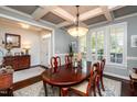 Elegant dining room with coffered ceilings, a large table, and shuttered windows at 2739 Elderberry Ln, Apex, NC 27539