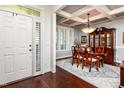 View of the Dining Room with a wood table, china cabinet and a decorative, coffered ceiling at 2739 Elderberry Ln, Apex, NC 27539