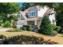 Beautifully landscaped front yard with lush greenery and a well-maintained lawn at 2739 Elderberry Ln, Apex, NC 27539