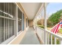 View of the covered side porch featuring white columns and railing at 2782 N Shiloh Rd, Garner, NC 27529