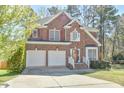 Charming two-story brick home featuring a two-car garage and a well-maintained lawn at 308 Sylvan Way, Chapel Hill, NC 27516