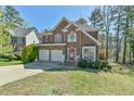 Charming two-story brick home with a two-car garage and well-manicured lawn at 308 Sylvan Way, Chapel Hill, NC 27516