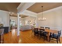 Open floor plan with dining area, hardwood floors, columns and living room at 3120 A Timberlyne Dr, Mebane, NC 27302