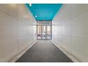 Entryway with gray walls, blue ceiling, and glass doors leading to the outside at 319 Fayetteville St # 207, Raleigh, NC 27601