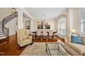 Bright living room featuring hardwood floors, elegant furniture, and a staircase at 4 Teahouse Ct, Durham, NC 27707