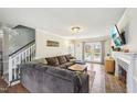 Inviting living room with a comfortable sectional, fireplace, and hardwood floors at 4532 Draper Rd, Raleigh, NC 27616