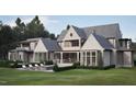 Spacious backyard featuring a pool, patio seating and lush landscaping at 4921 Foxridge Dr, Raleigh, NC 27614