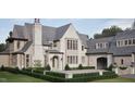 An elegant home with a stone exterior, arched entry and professionally landscaped front yard at 4921 Foxridge Dr, Raleigh, NC 27614
