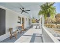 Relaxing front porch with wicker chairs, ceiling fans, and beautiful hanging plants, perfect for enjoying outdoors at 523 N Main St, Graham, NC 27253