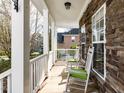 Charming covered front porch featuring rocking chairs and stone accents, perfect for relaxation at 543 Chatham Forest Dr, Pittsboro, NC 27312