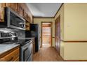 Kitchen showing stainless appliances and access to a pantry behind a wooden door at 5437 Grasshopper Rd, Raleigh, NC 27610