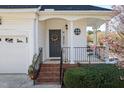 Welcoming front porch with brick steps, decorative wreath on door, and well-maintained landscaping at 5569 Sea Daisy Dr, Raleigh, NC 27606