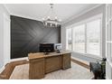Modern home office featuring a sleek desk, statement wall, and plenty of natural light for a productive workspace at 6108 Norwood Place Ct, Raleigh, NC 27613