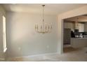 Elegant dining room with modern chandelier; kitchen visible in the background at 65 Stream View Way, Spring Hope, NC 27882