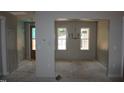 Chandelier-lit dining area featuring large windows, adjacent to an unfinished room at 65 Stream View Way, Spring Hope, NC 27882