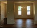 Bright dining room featuring hardwood floors, a modern chandelier, and large windows at 65 Stream View Way, Spring Hope, NC 27882