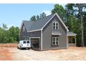 View of the home's exterior, featuring gray siding, white trim, and an attached garage at 65 Stream View Way, Spring Hope, NC 27882