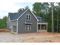 A two-story new construction home features gray siding and an attached garage at 65 Stream View Way, Spring Hope, NC 27882