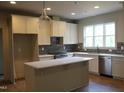 Bright kitchen featuring an island, stainless steel appliances, and stylish cabinetry at 65 Stream View Way, Spring Hope, NC 27882