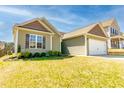 A charming single-story home with a manicured lawn and attached garage in a suburban neighborhood at 6808 Lakinsville Ln, Raleigh, NC 27610