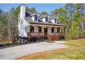 Beautiful exterior elevation, showcasing a porch, a manicured lawn and a gravel driveway at 692 Port Dr, Henderson, NC 27537