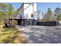 A full rear view highlighting the walkout basement and deck at 692 Port Dr, Henderson, NC 27537