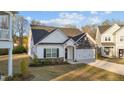 Attractive single-Gathering home with stone and vinyl siding, a well-kept lawn, and a welcoming front entrance at 75 Red Crabapple Ct, Clayton, NC 27520