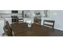 Open floor plan showing modern dining area, stainless steel appliances, and living space at 818 Bright Nova Way, Wendell, NC 27591