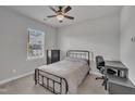 Neutral bedroom featuring a window, a bed, a desk, and a dresser for a comfortable living space at 818 Lilyquist Way, Wake Forest, NC 27587