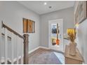 Light-filled entryway offering access to a serene outdoor lake view from the main level of the home at 818 Lilyquist Way, Wake Forest, NC 27587