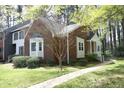 Lovely brick home with mature tree in the yard, charming cream trim, and inviting front porch at 8310 Wycombe Ln, Raleigh, NC 27615