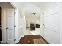 Inviting foyer with gleaming hardwood floors, leading to a spacious living area with a fireplace at 8310 Wycombe Ln, Raleigh, NC 27615